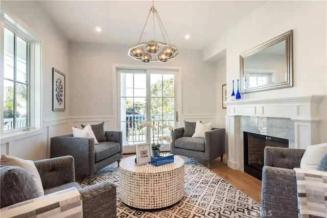 a living room with furniture fireplace and window
