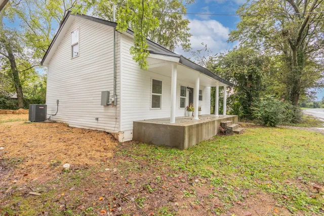 a view of a house with a yard and sitting area
