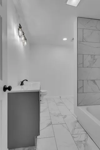 a bathroom with a bathtub and shower