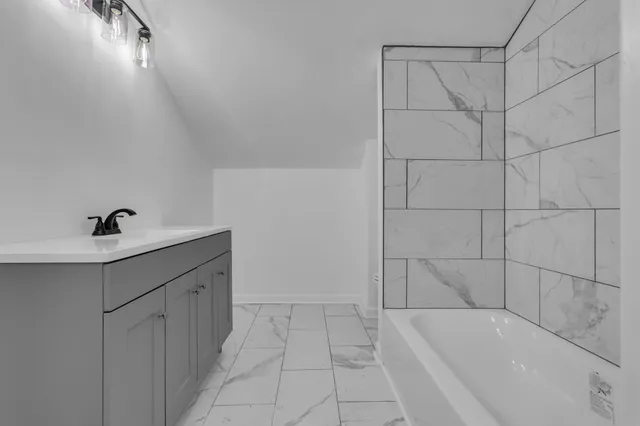 a bathroom with a bathtub and shower