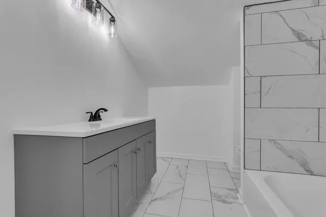 a bathroom with a bathtub and a shower