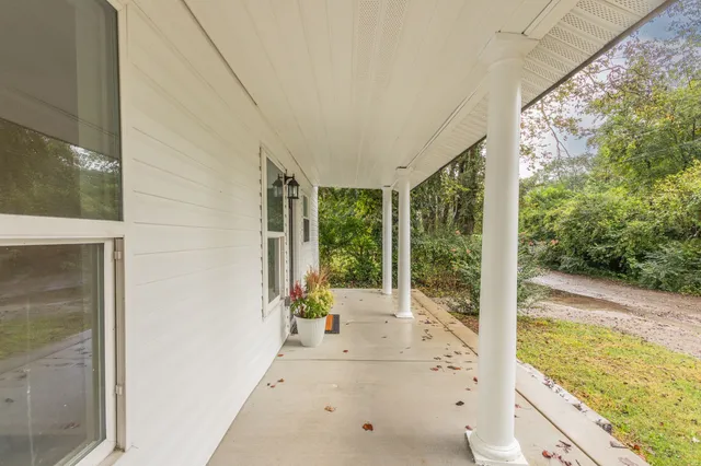 a view of a porch with wooden floor
