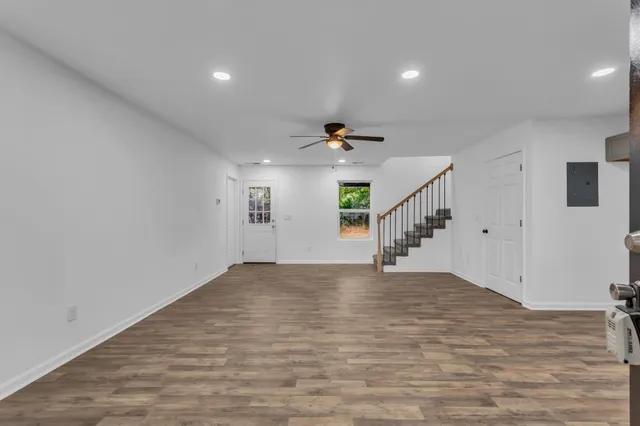 a view of empty room with wooden floor