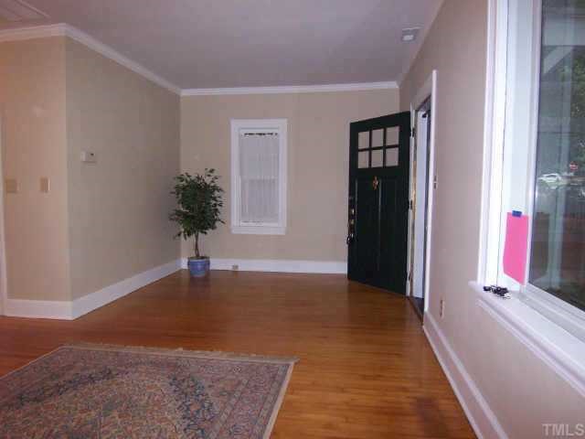 607 Adams Street Raleigh, NC 27605 - Photo 3 of 9 a view of a hallway with wooden floor and windows