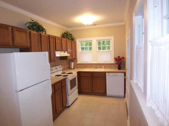 607 Adams Street Raleigh, NC 27605 - Photo 4 of 9 a kitchen with a refrigerator stove and sink