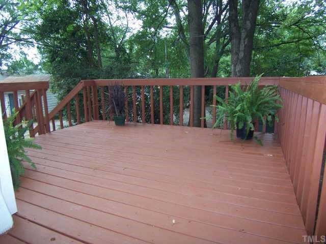 607 Adams Street Raleigh, NC 27605 - Photo 7 of 9 a view of backyard with wooden fence and trees
