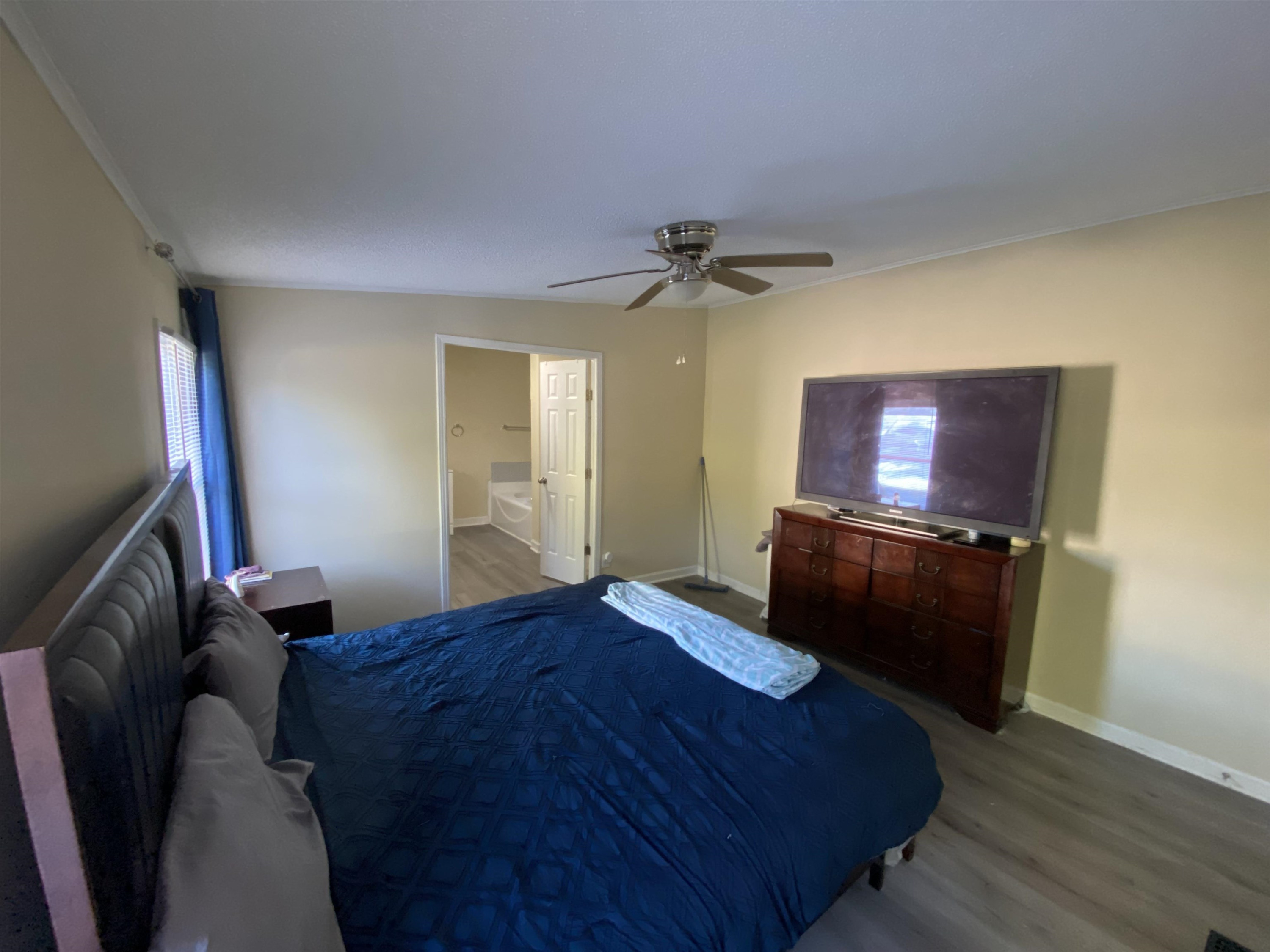 6036 Rock Quarry Road Raleigh, NC 27610 - Photo 12 of 17 a bedroom with a bed and a flat screen tv