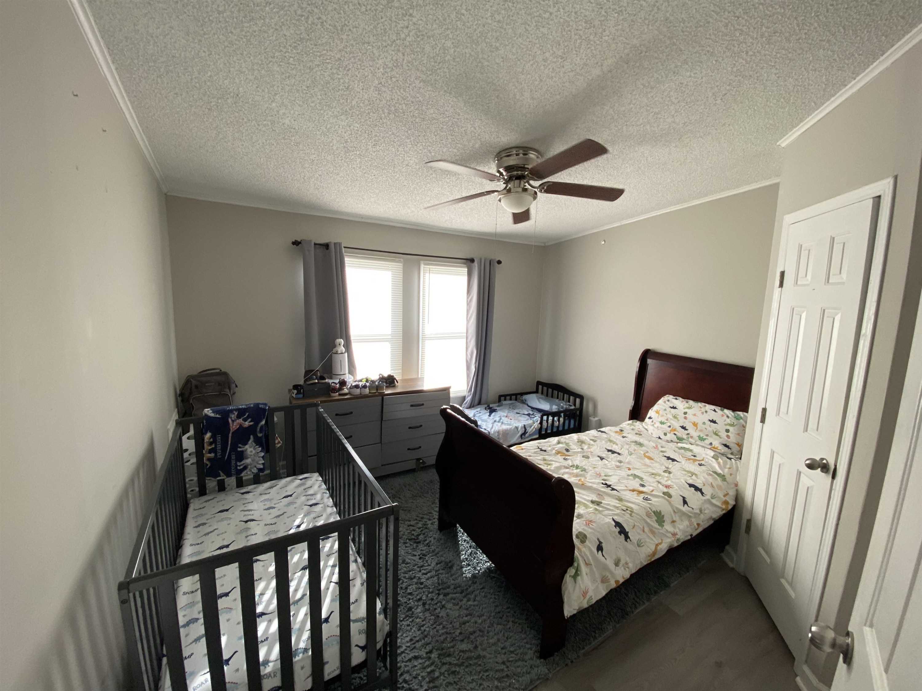 6036 Rock Quarry Road Raleigh, NC 27610 - Photo 16 of 17 a bed room with a bed and a chandelier