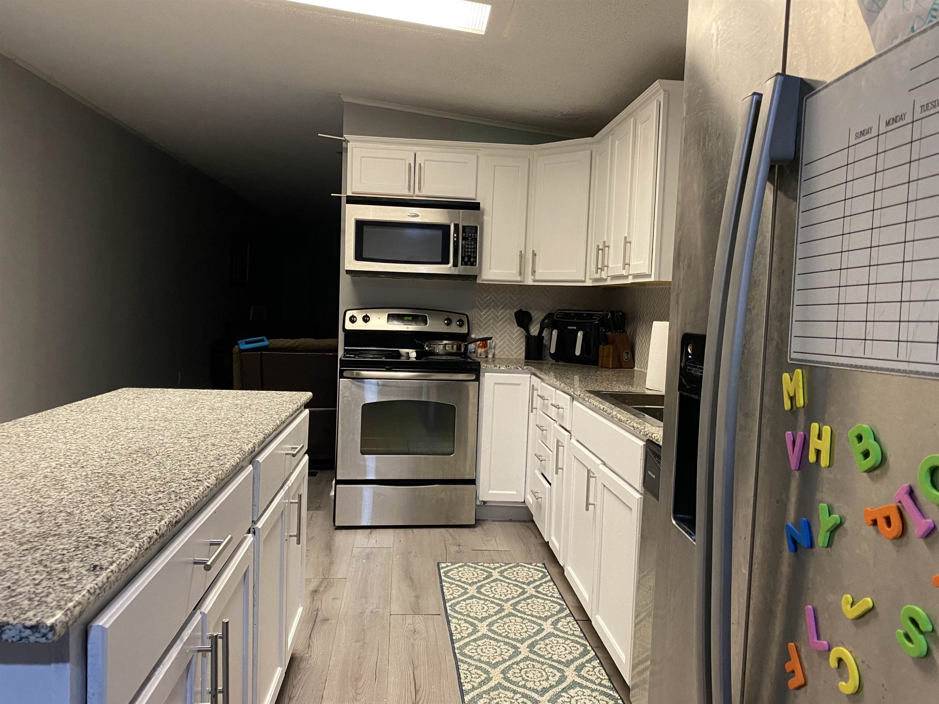 6036 Rock Quarry Road Raleigh, NC 27610 - Photo 9 of 17 a kitchen with stainless steel appliances granite countertop a sink stove and refrigerator