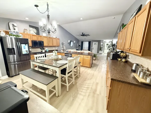 a view of a dining room with furniture a chandelier and wooden floor