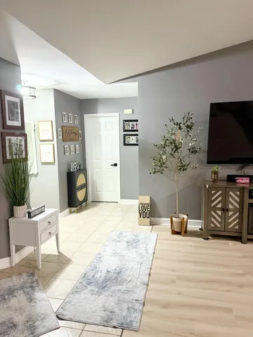 a bedroom with furniture and a flat screen tv