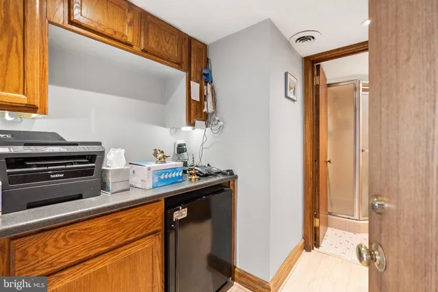 a kitchen with stainless steel appliances a sink cabinets and a window