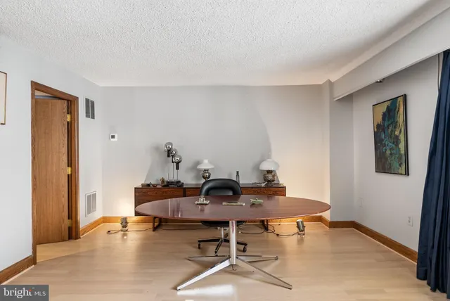 a workspace with furniture and wooden floor