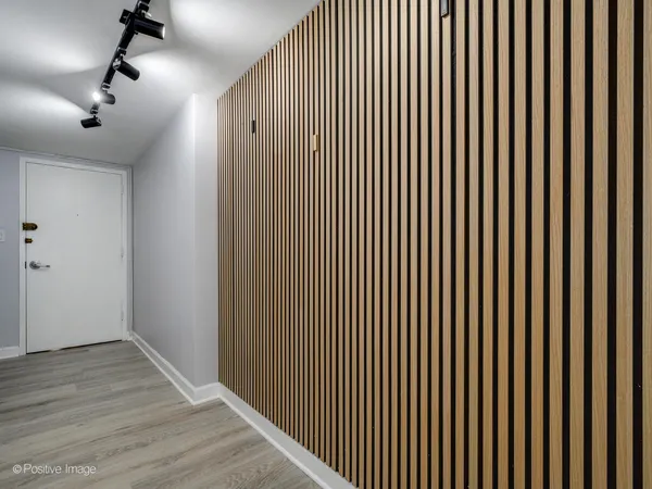 a view of a room with wooden floor