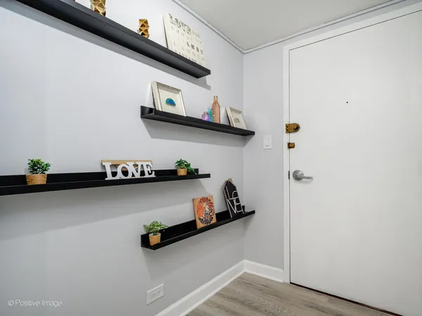 a view of storage and utility room with wooden floor