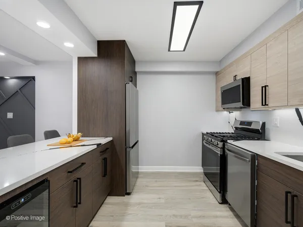 a kitchen with stainless steel appliances granite countertop a refrigerator and a sink