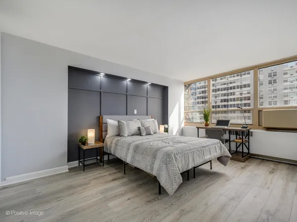 a bedroom with a bed and a table in it