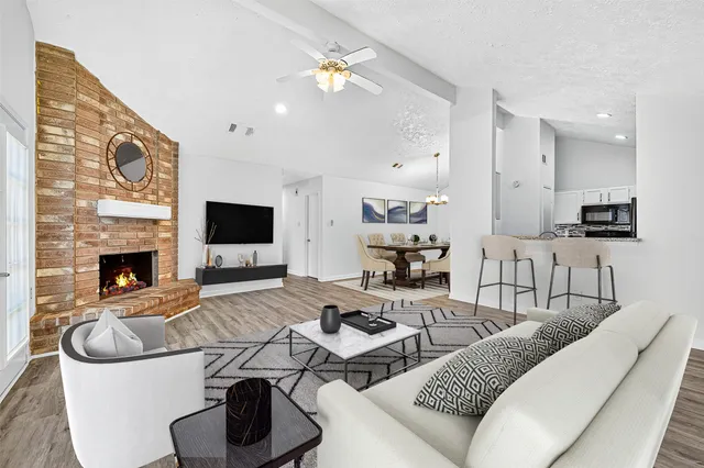 a kitchen with cabinets appliances and wooden floor