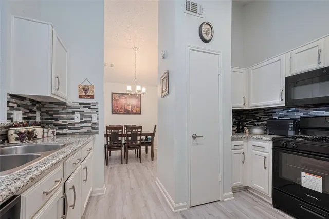 a kitchen with sink and refrigerator