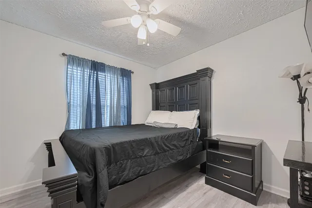 a view of backyard with wooden fence