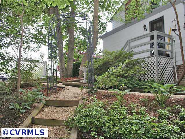 7158 Barkbridge Road Chesterfield, VA 23832 - Photo 3 of 10 a view of a yard with plants and a bench