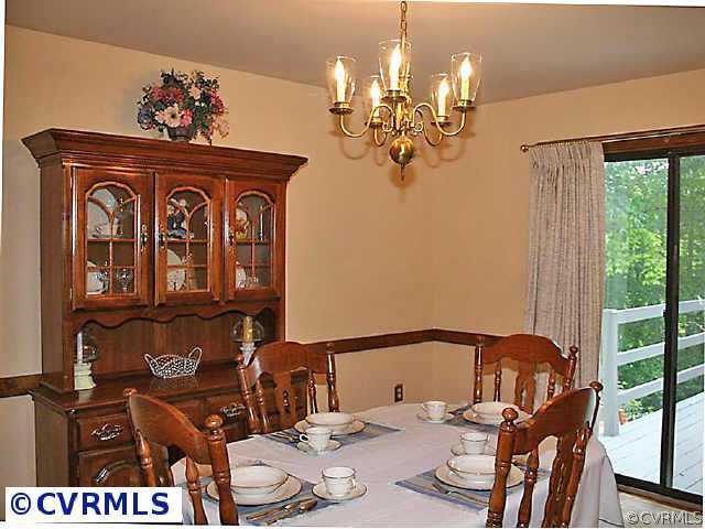 7158 Barkbridge Road Chesterfield, VA 23832 - Photo 6 of 10 a view of a dining room with furniture a chandelier and large windows