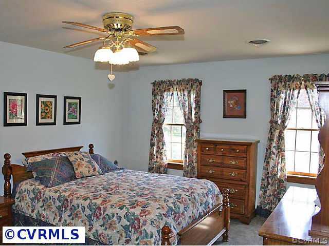 7158 Barkbridge Road Chesterfield, VA 23832 - Photo 8 of 10 a bedroom with a bed and dresser with mirror