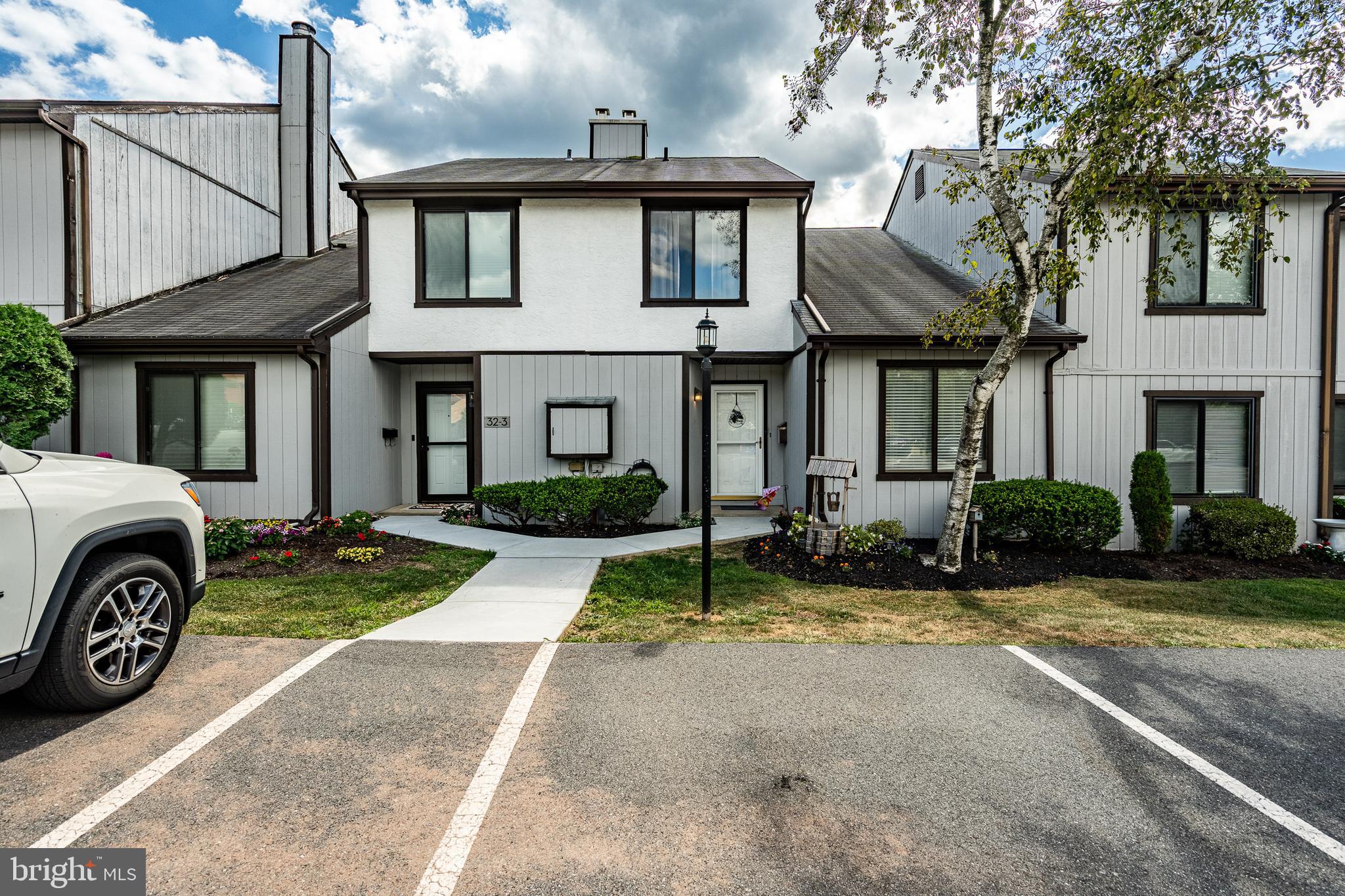 a view of a house with a patio and a yard