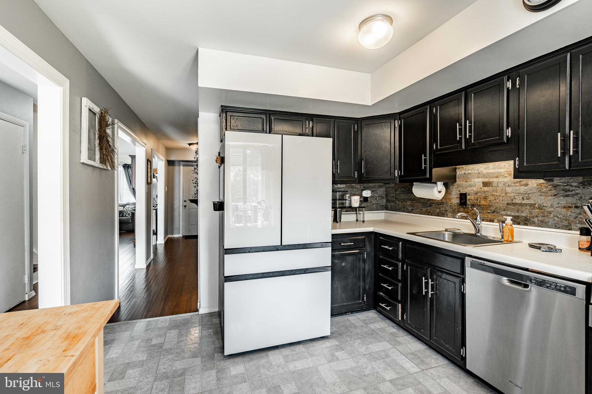 32-4 Wister Way Reading, PA 19606 - Photo 11 of 47 a kitchen with a refrigerator sink and cabinets
