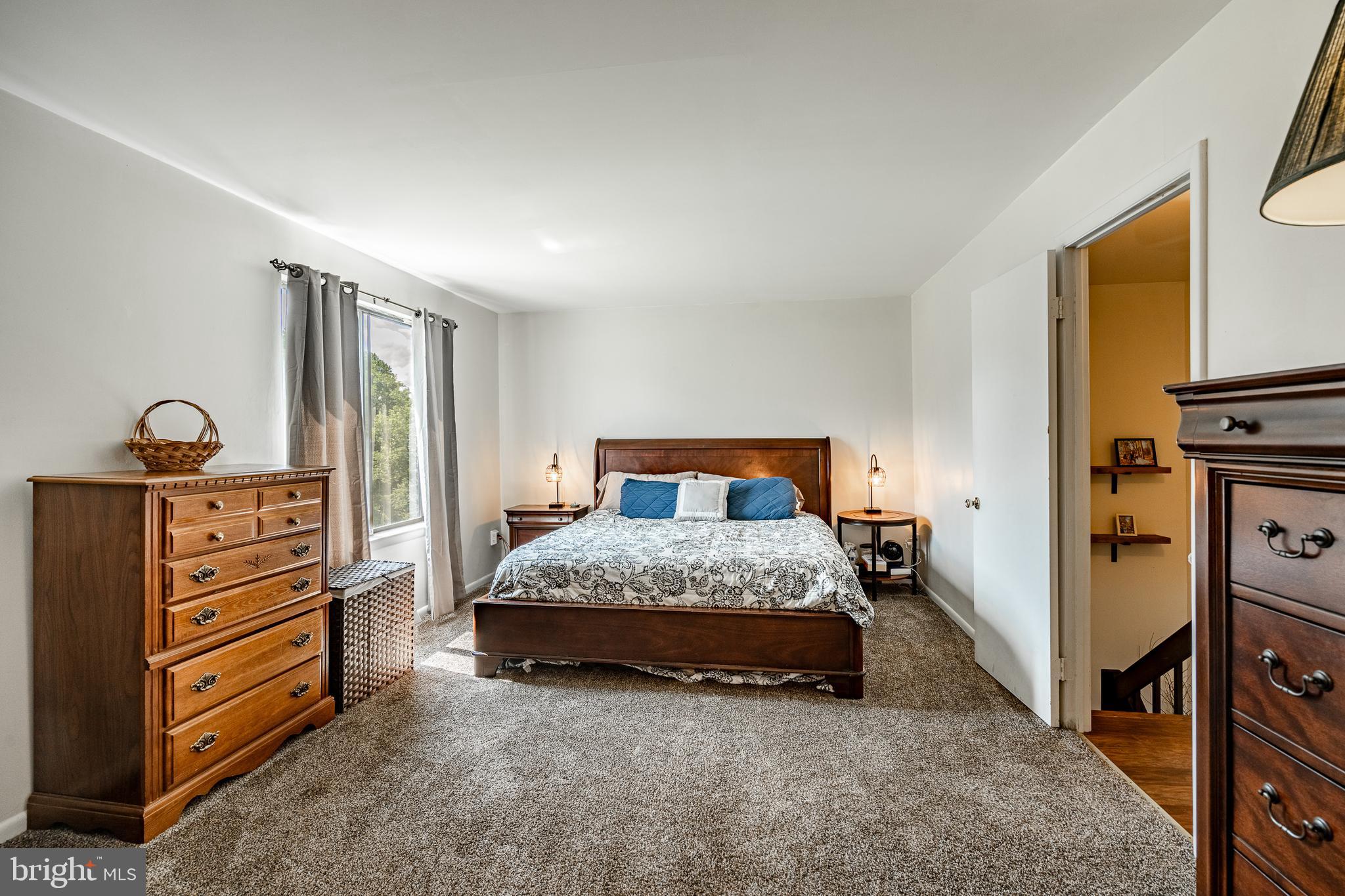 32-4 Wister Way Reading, PA 19606 - Photo 19 of 47 a bedroom with a bed and a flat tv screen on dresser