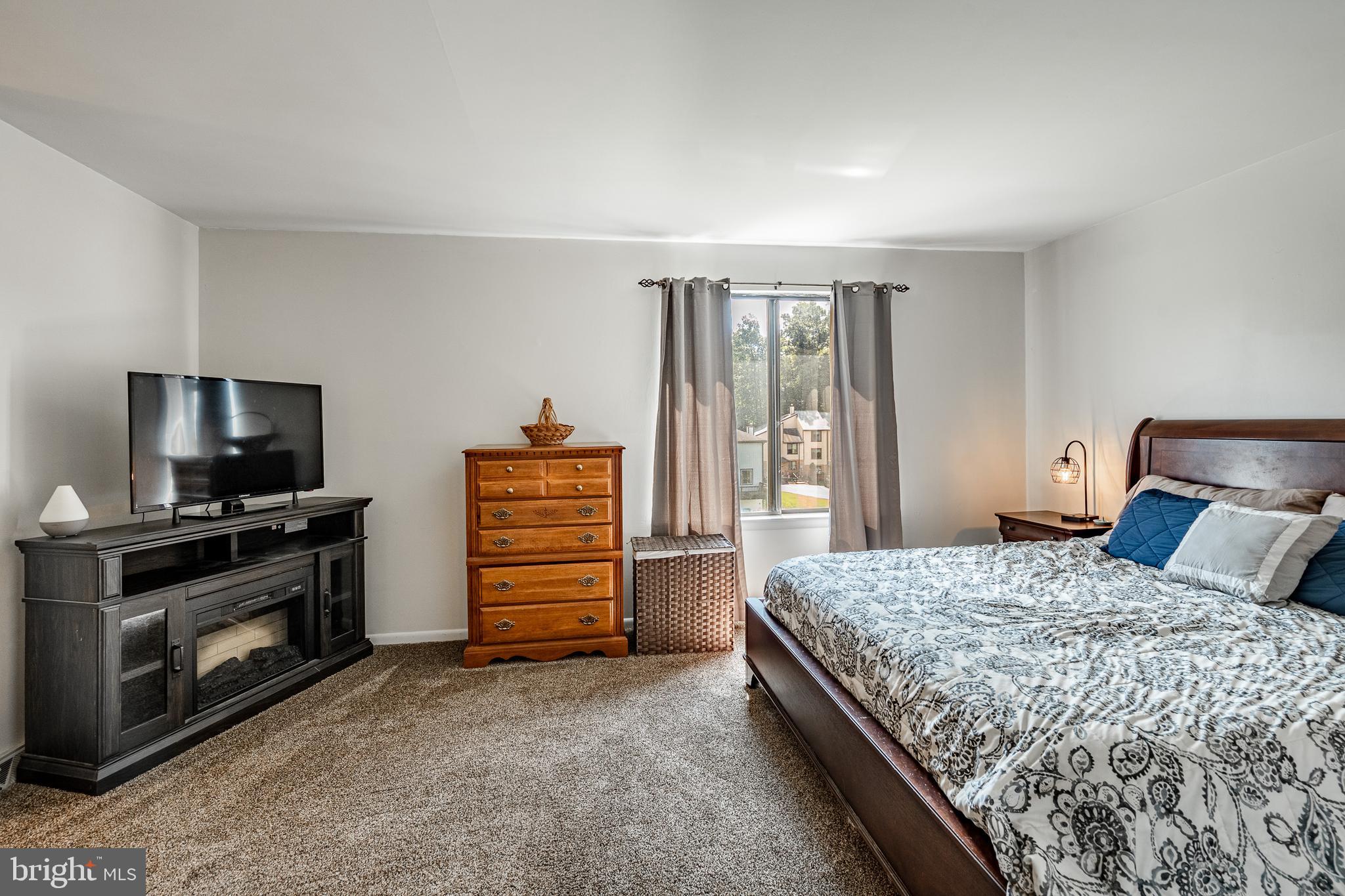 32-4 Wister Way Reading, PA 19606 - Photo 20 of 47 a bedroom with a bed and a television in it