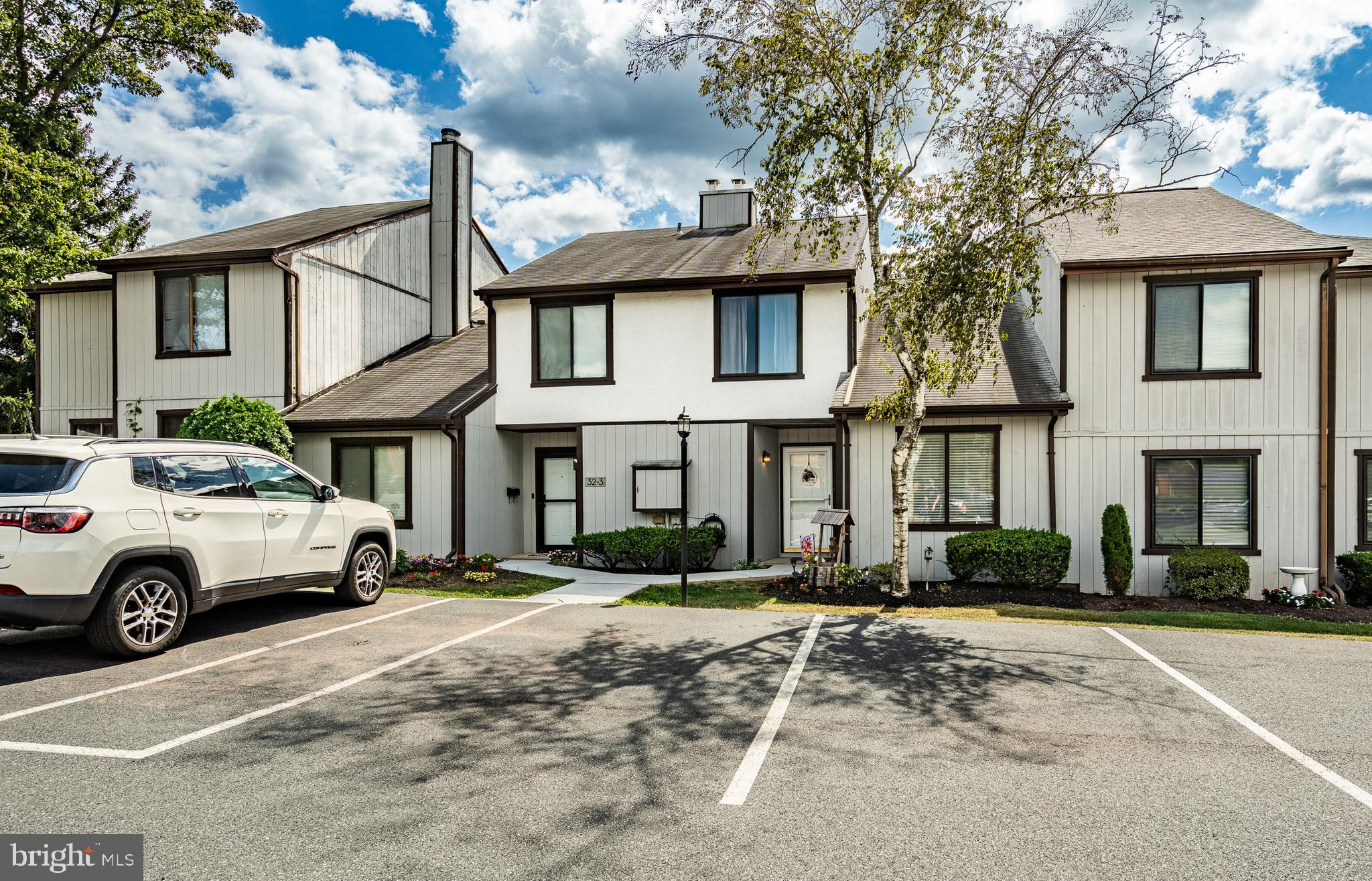 32-4 Wister Way Reading, PA 19606 - Photo 2 of 47 a front view of a house with a yard