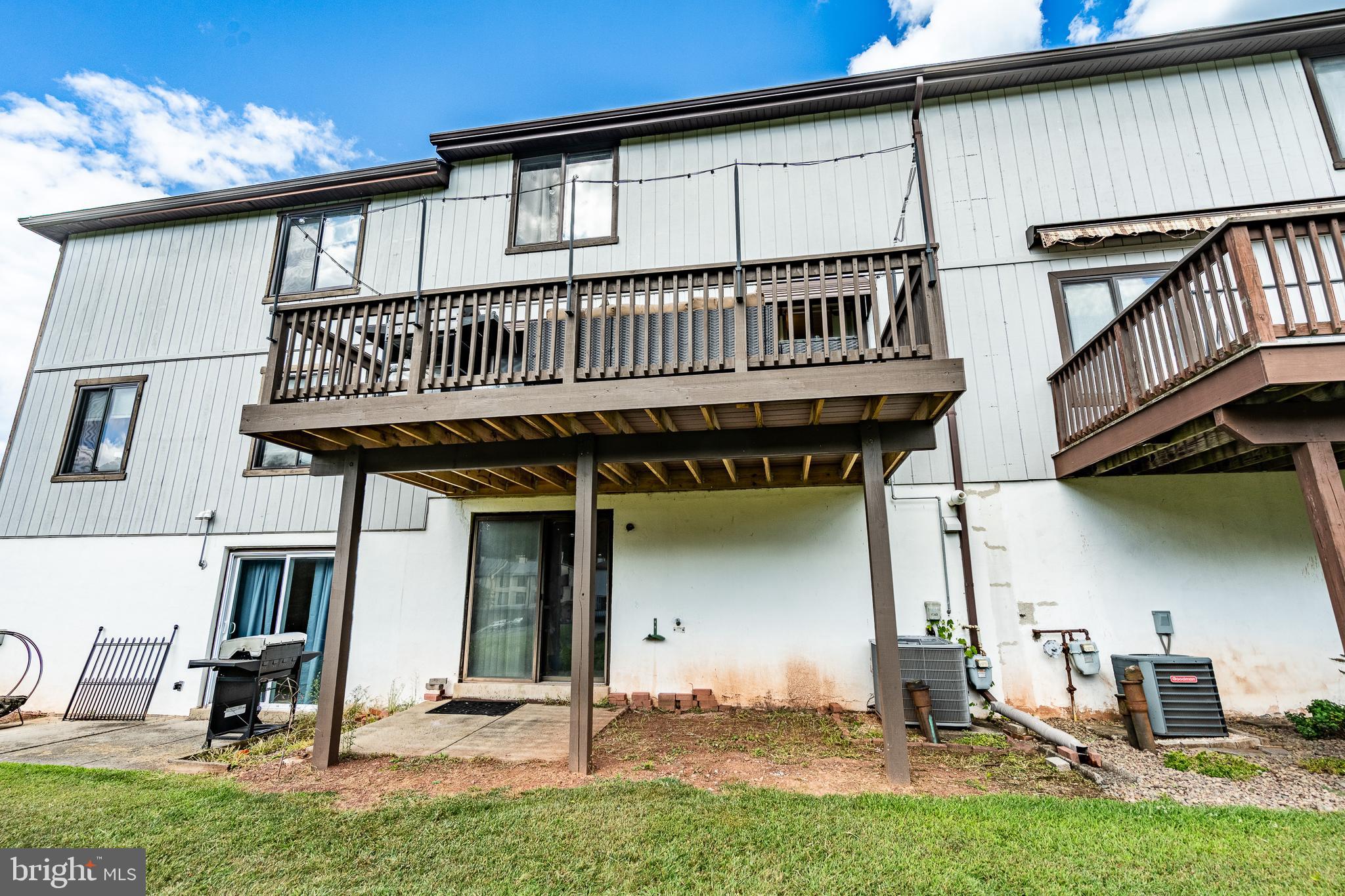 32-4 Wister Way Reading, PA 19606 - Photo 34 of 47 a view of a house with wooden deck and furniture