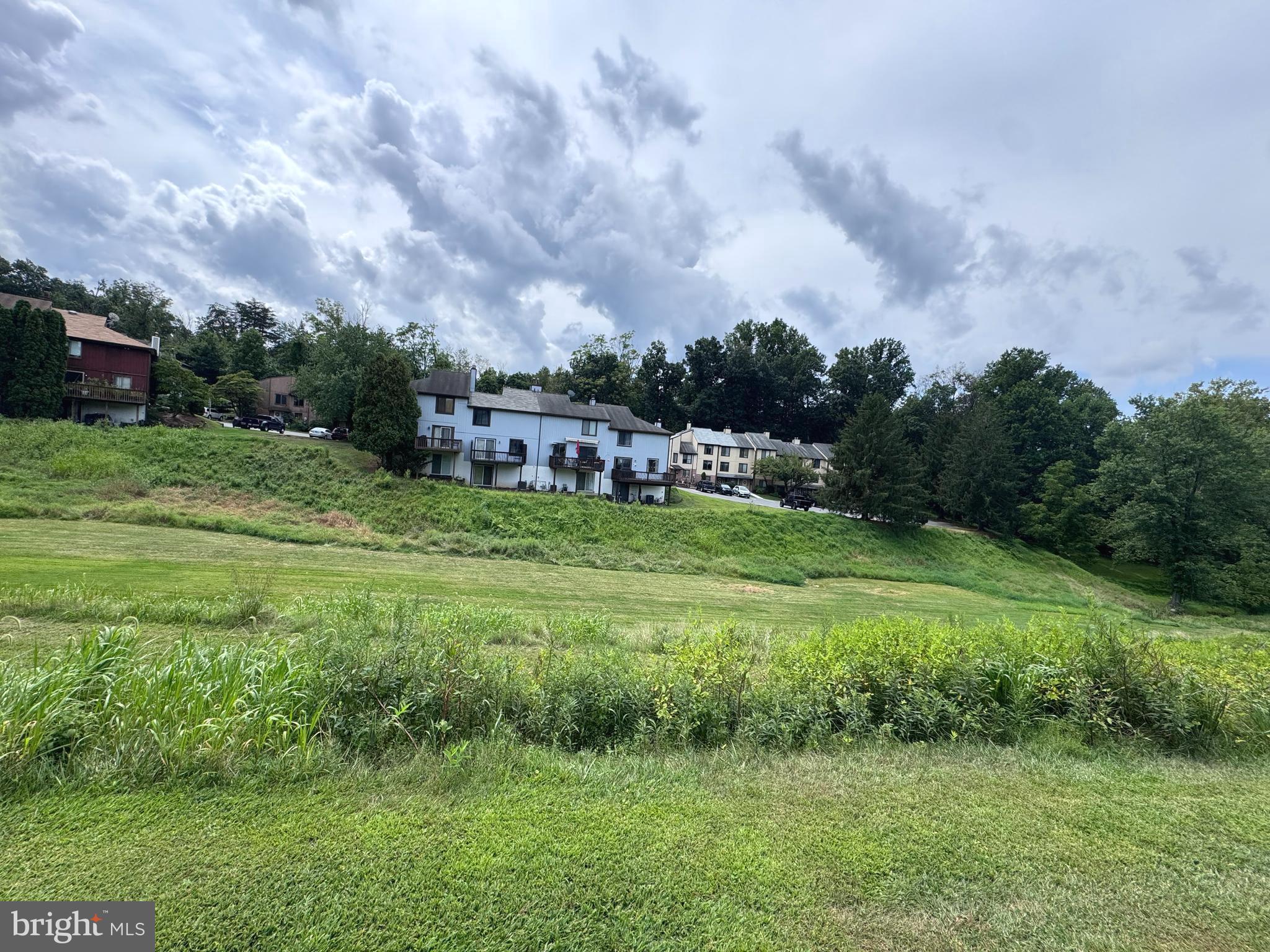 32-4 Wister Way Reading, PA 19606 - Photo 42 of 47 a view of a big yard with a house in the background