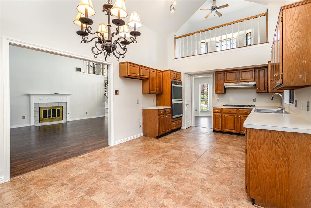 6029 Buffridge Trail Dallas, TX 75252 - Photo 11 of 30 a view of a living room kitchen and a chandelier