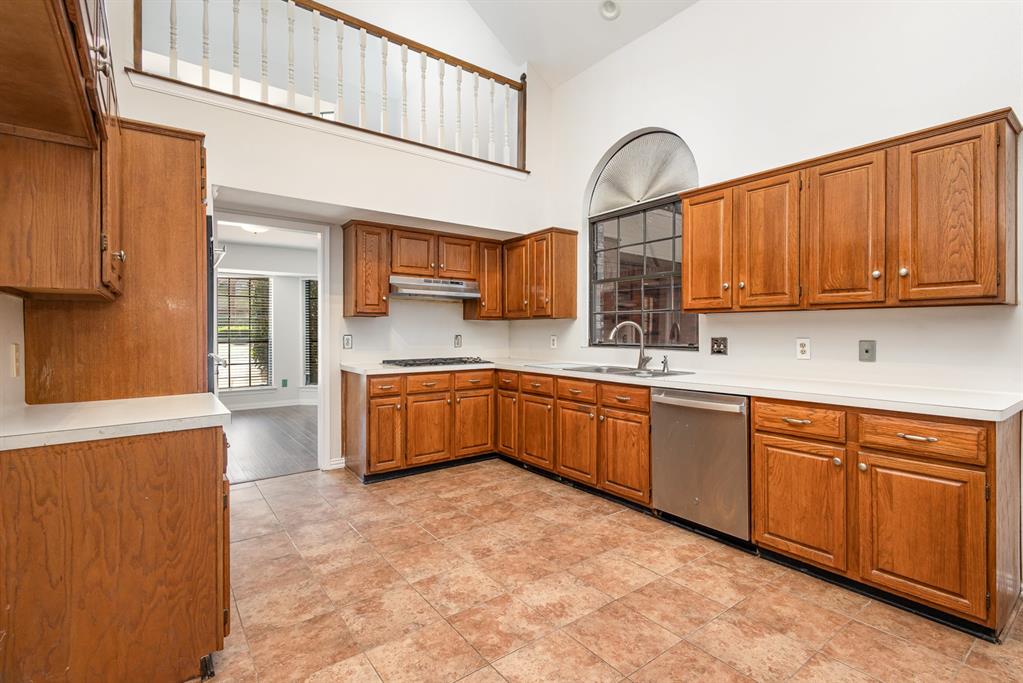 6029 Buffridge Trail Dallas, TX 75252 - Photo 12 of 30 a kitchen with stainless steel appliances granite countertop a stove sink and cabinets