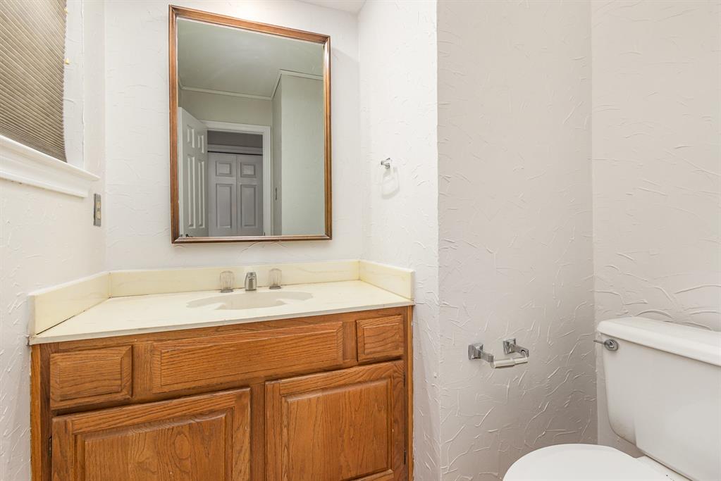 6029 Buffridge Trail Dallas, TX 75252 - Photo 19 of 30 a bathroom with a toilet sink and mirror