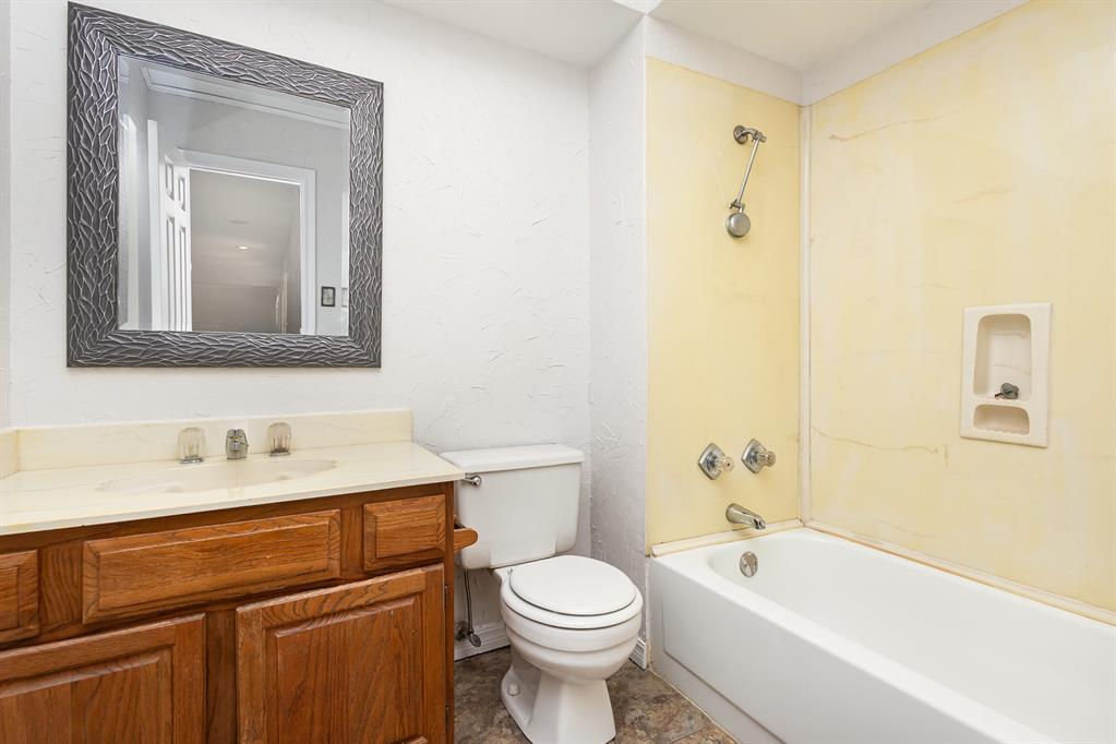 6029 Buffridge Trail Dallas, TX 75252 - Photo 28 of 30 a bathroom with a sink a toilet and a bathtub