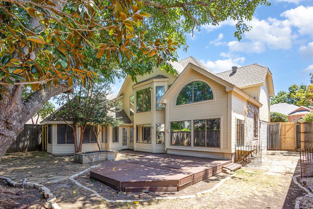 6029 Buffridge Trail Dallas, TX 75252 - Photo 30 of 30 a view of a house with brick walls and a tree