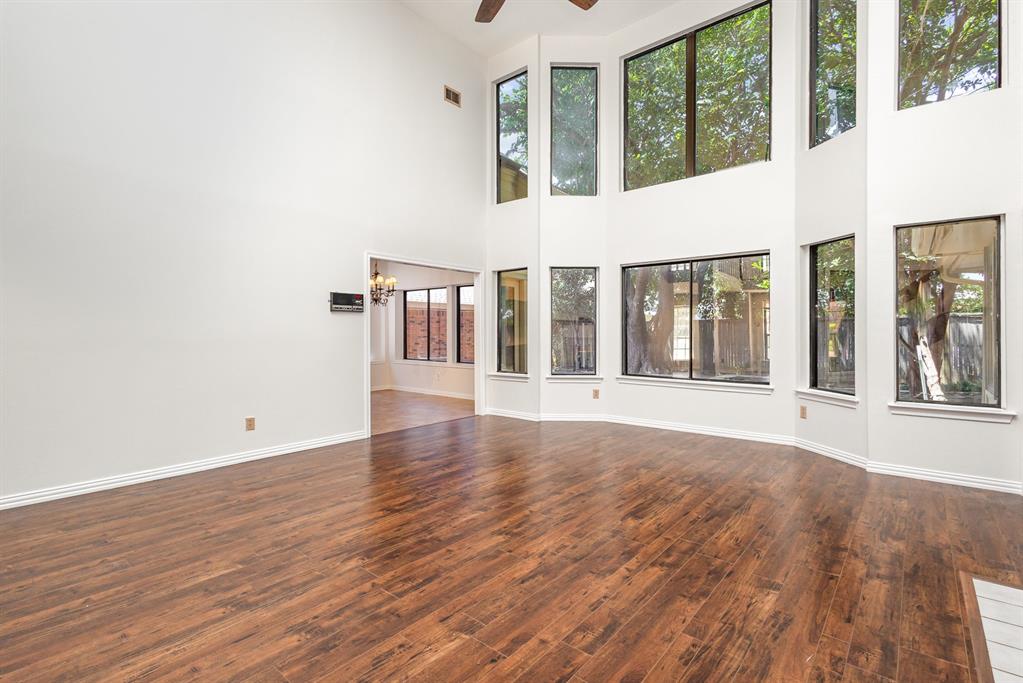 6029 Buffridge Trail Dallas, TX 75252 - Photo 3 of 30 wooden floor in an empty room with a window