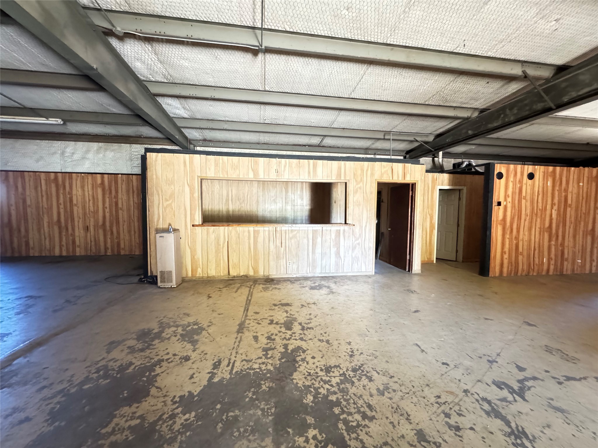 51 New Wehdem Road Brenham, TX 77833 - Photo 11 of 20 a view of an empty room with wooden floor and door