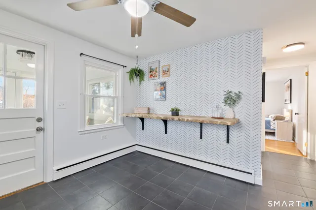 a kitchen with stainless steel appliances a white stove top oven and white cabinets