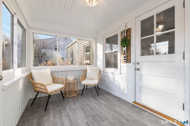 a bathroom with a toilet a sink and a large window