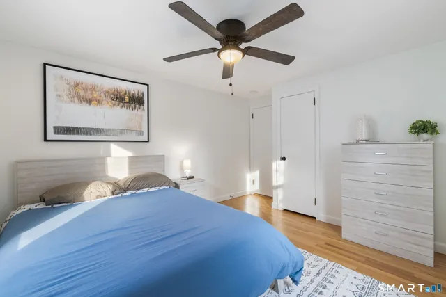 a bathroom with a granite countertop sink mirror and toilet