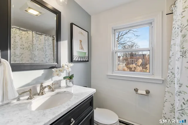 a bathroom with a sink vanity and a mirror