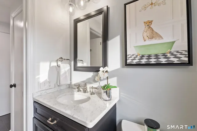 a bedroom with a bed and a painting on the wall