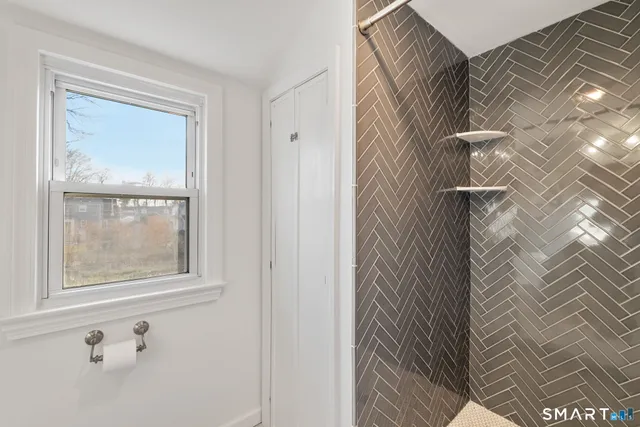 a living room with a couch and a dresser