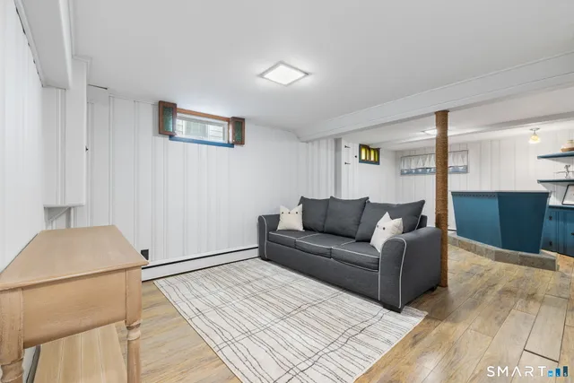 a living room with furniture and a painting on the wall