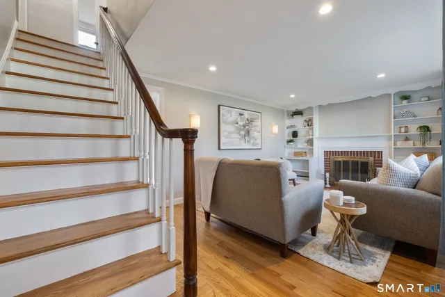 a living room with furniture a fireplace and a wooden floor