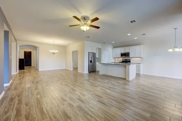a view of kitchen with granite countertop cabinets stainless steel appliances and a window